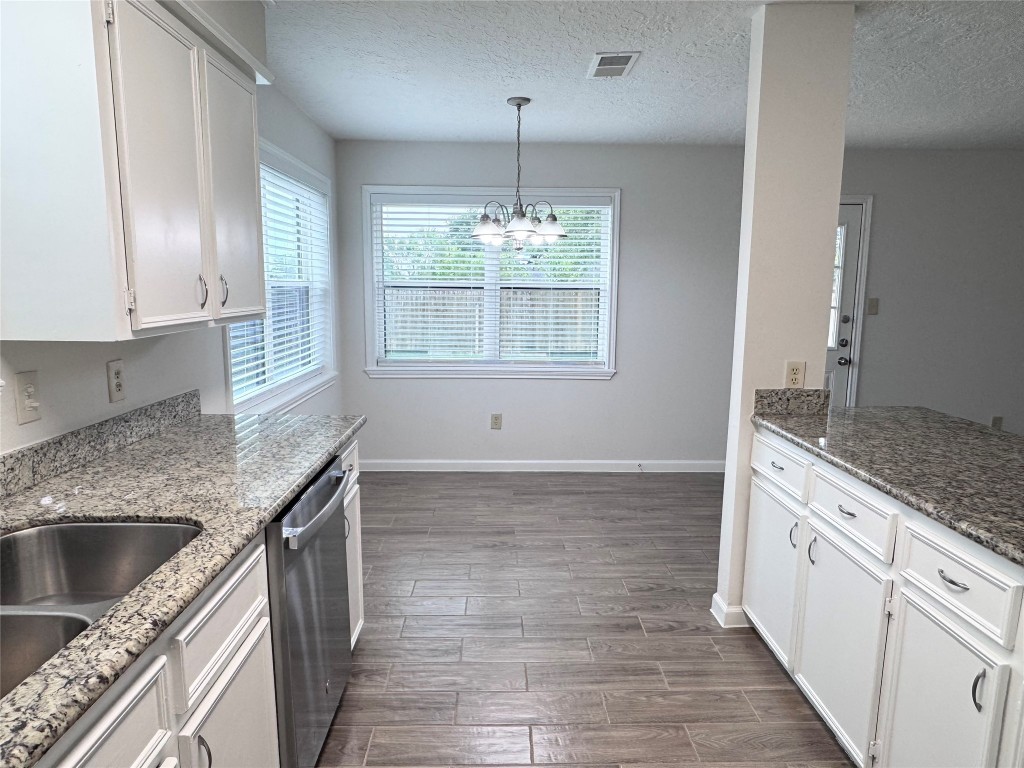 2402 Barak Lane Bryan, TX 77802 - Photo 20 of 25 a kitchen with granite countertop a stove sink and cabinets