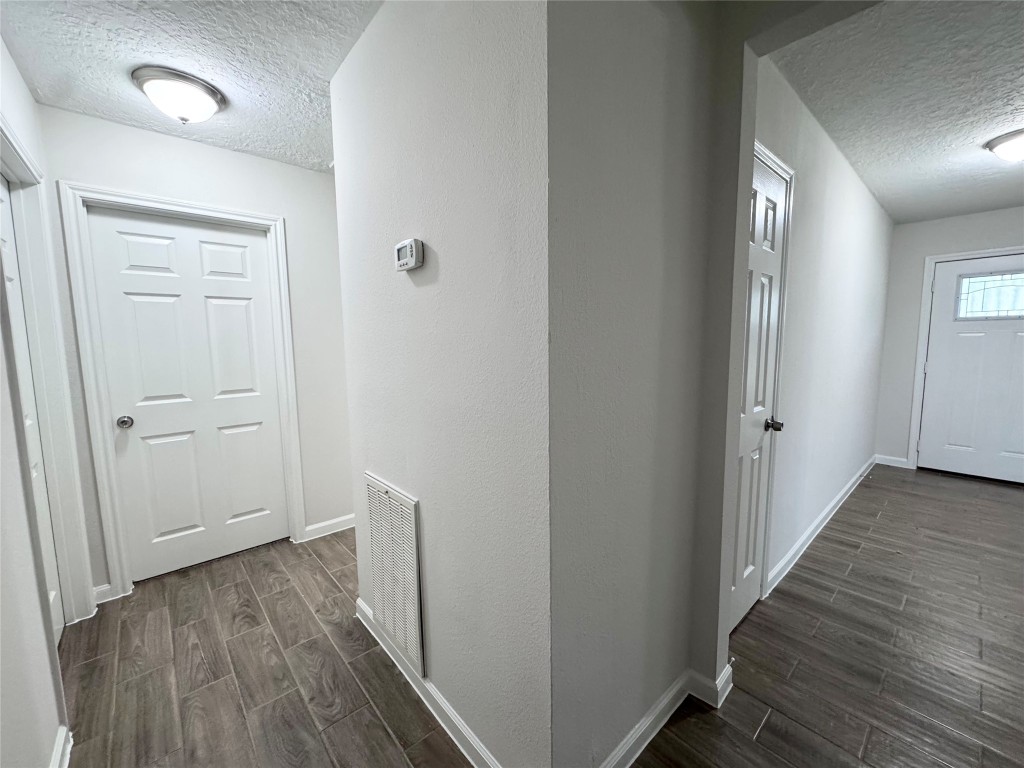 2402 Barak Lane Bryan, TX 77802 - Photo 21 of 25 a view of a hallway with wooden floor