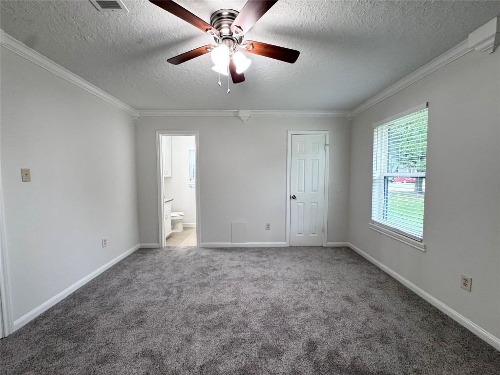 2402 Barak Lane Bryan, TX 77802 - Photo 24 of 25 an empty room with chandelier fan and windows