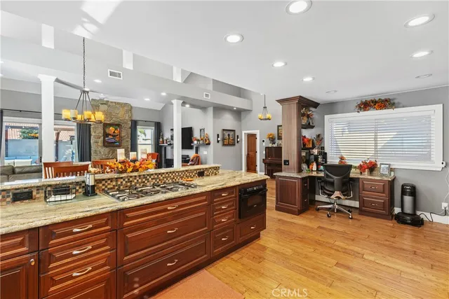 a living room with stainless steel appliances kitchen island granite countertop lots of counter top space