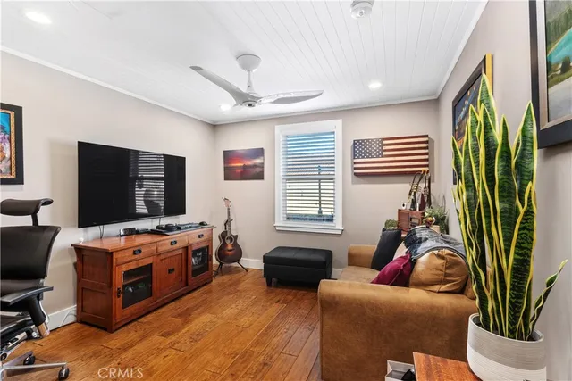a bedroom with furniture and a flat screen tv