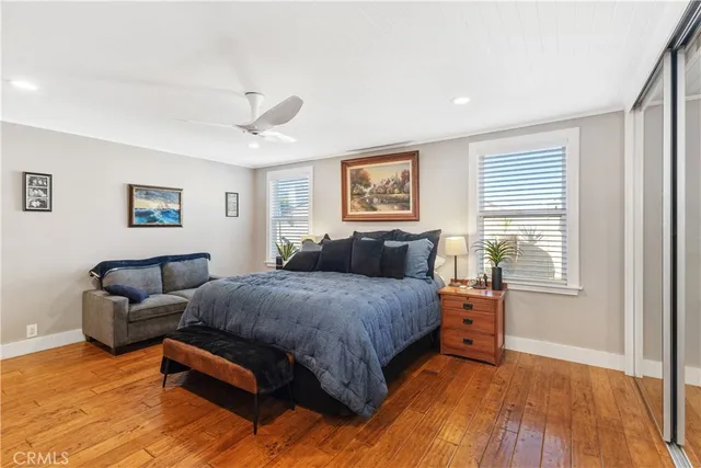 a bedroom with a bed couch and a window