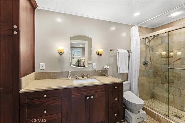 a bathroom with a sink vanity mirror and toilet