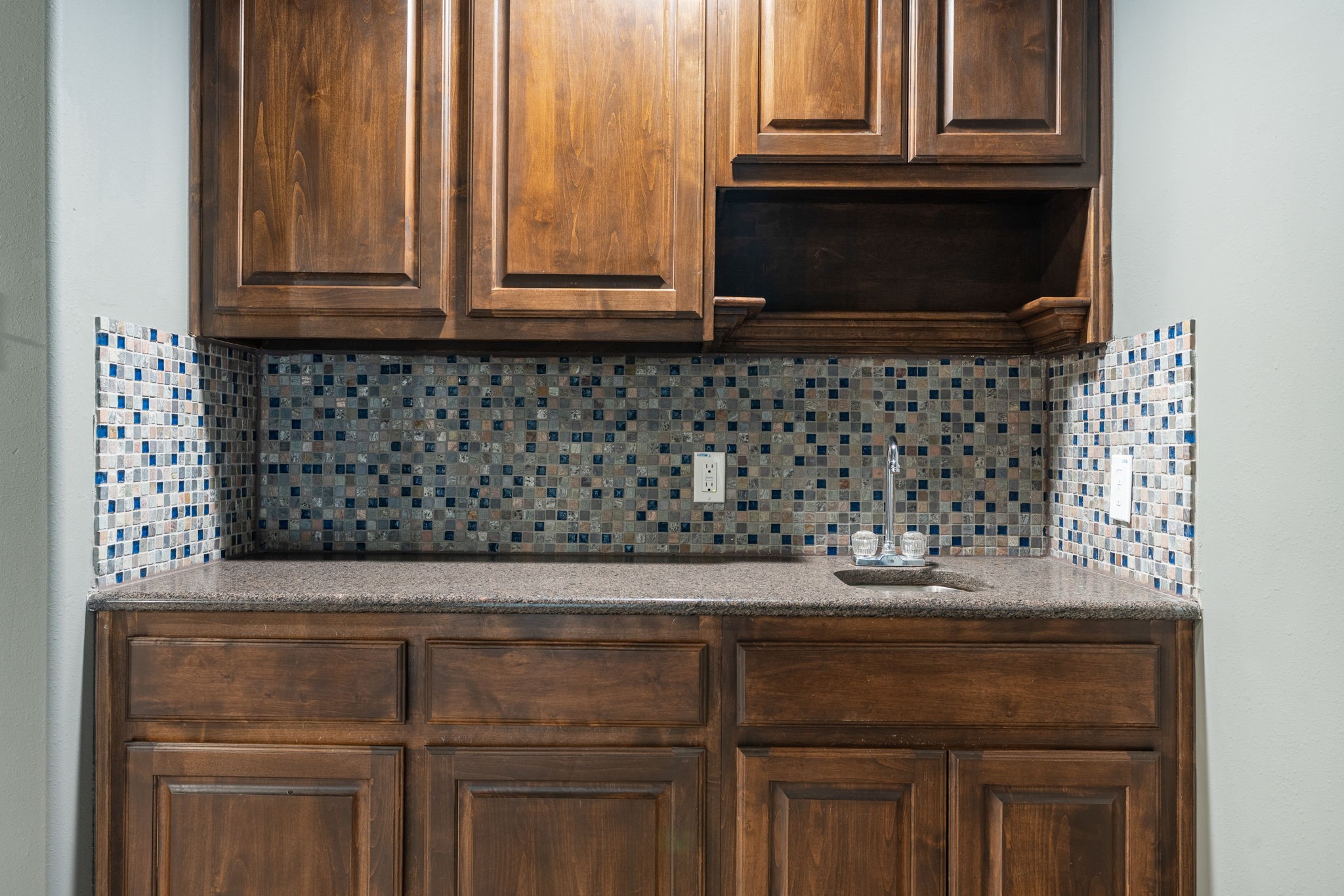 2115 Graystone Ridge Drive Conroe, TX 77304 - Photo 32 of 47 Media room includes a stylish wet bar, perfect for entertaining with convenient space for refreshments, snacks, and drinks while enjoying movies or game nights.