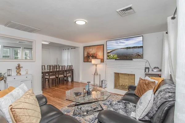 a living room with furniture and a fireplace