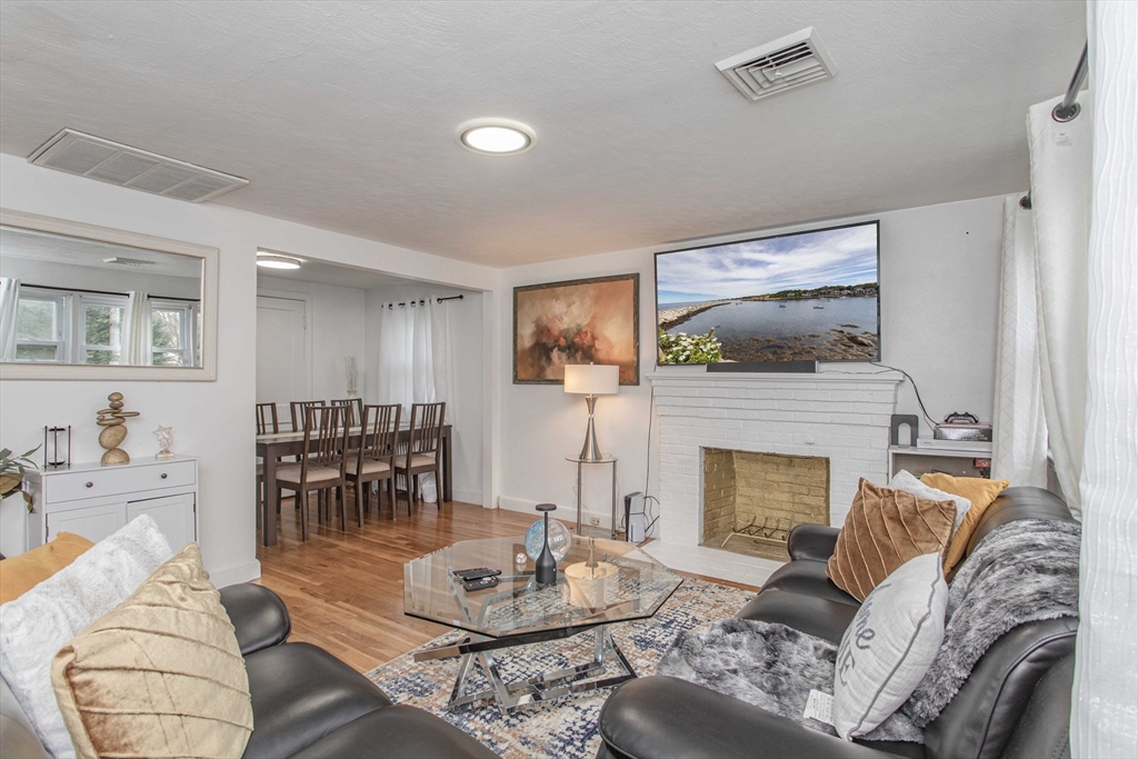 7 Scannell Road Randolph, MA 02368 - Photo 11 of 34 a living room with furniture and a fireplace