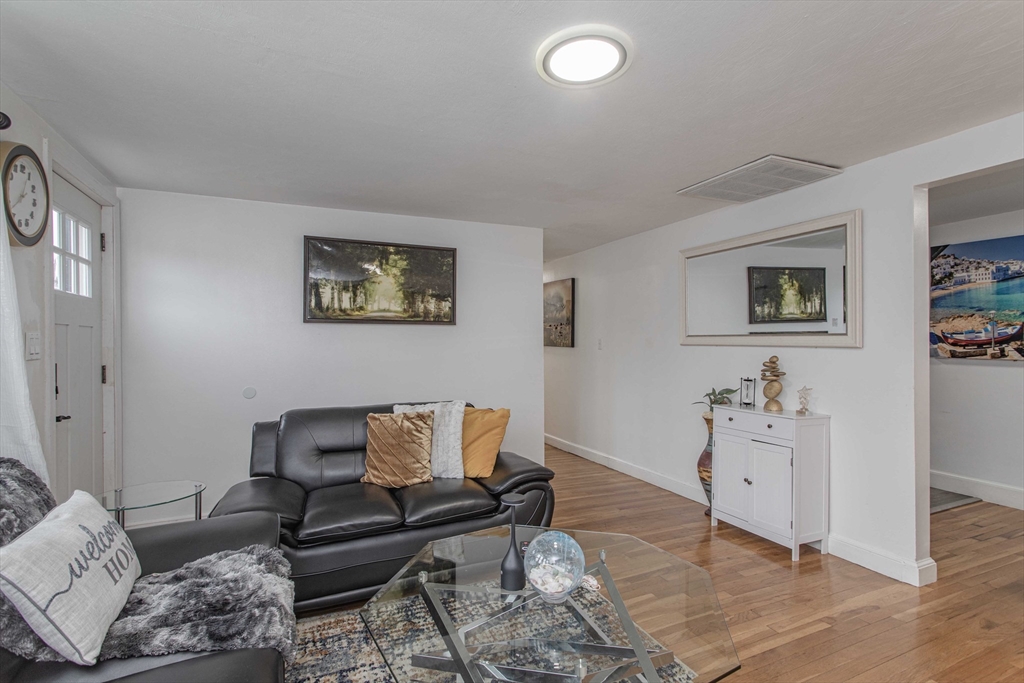 7 Scannell Road Randolph, MA 02368 - Photo 13 of 34 a living room with furniture and painting on the wall
