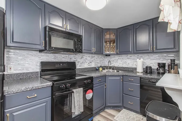 a kitchen with a sink stove and microwave