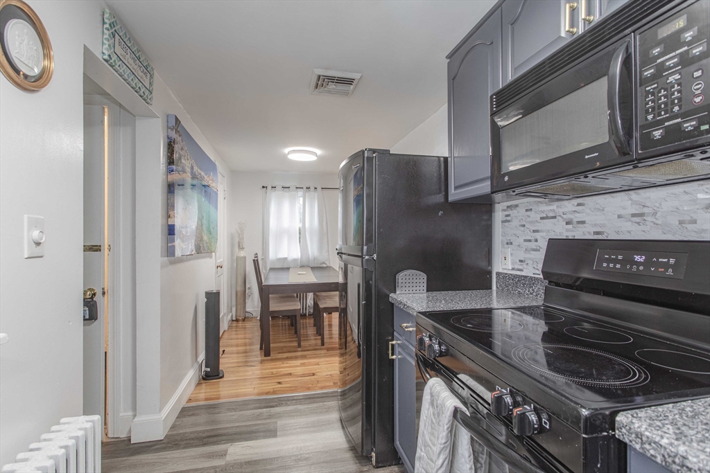 7 Scannell Road Randolph, MA 02368 - Photo 20 of 34 a kitchen with a stove and a microwave