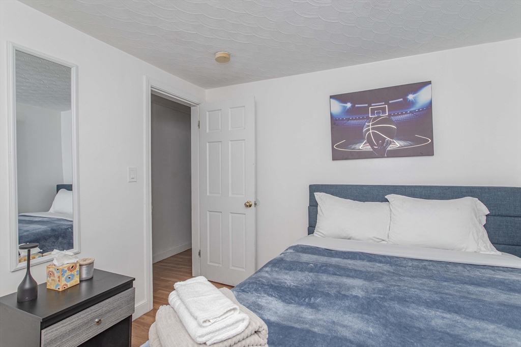 7 Scannell Road Randolph, MA 02368 - Photo 23 of 34 a bedroom with a bed and a couch