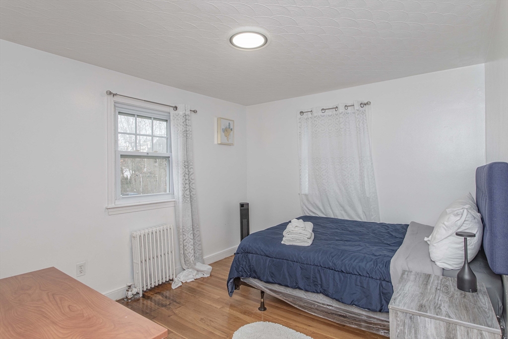 7 Scannell Road Randolph, MA 02368 - Photo 26 of 34 a living room with furniture and a wooden floor