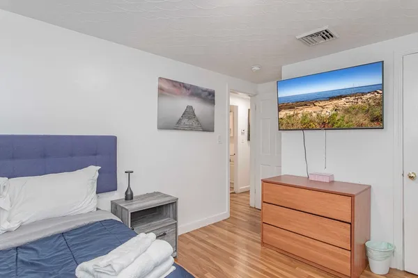 a room with a bed and a flat screen tv