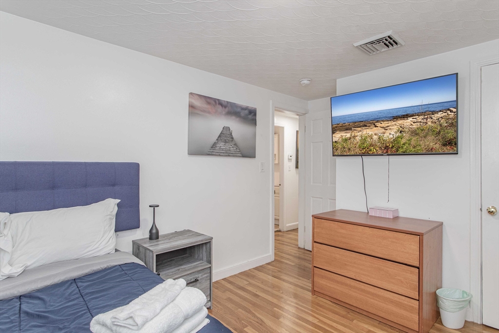 7 Scannell Road Randolph, MA 02368 - Photo 28 of 34 a room with a bed and a flat screen tv
