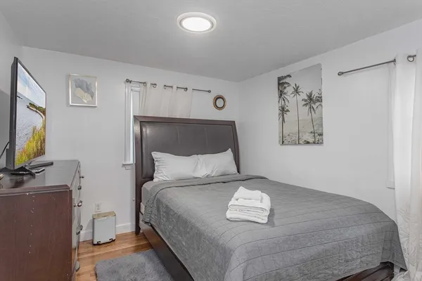 a bedroom with a bed and a flat screen tv