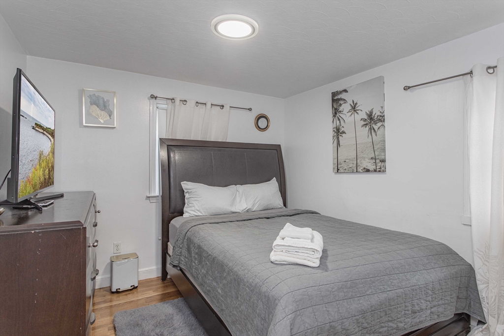 7 Scannell Road Randolph, MA 02368 - Photo 29 of 34 a bedroom with a bed and a flat screen tv