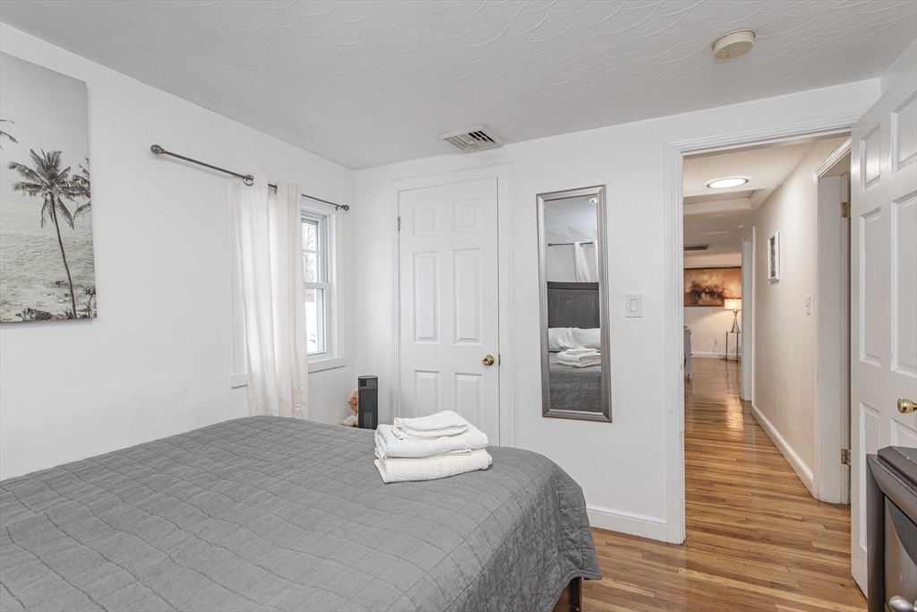 7 Scannell Road Randolph, MA 02368 - Photo 31 of 34 a bedroom with a bed and a walk in closet