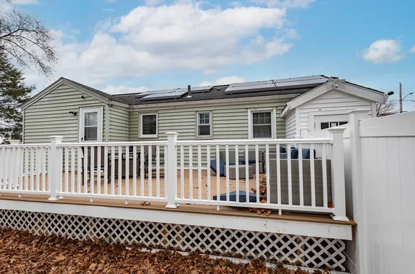 a view of a house with a wooden fence