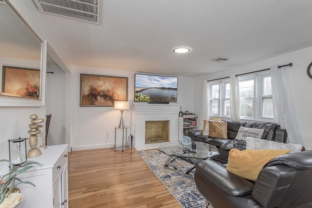 7 Scannell Road Randolph, MA 02368 - Photo 10 of 34 a living room with furniture and a fireplace