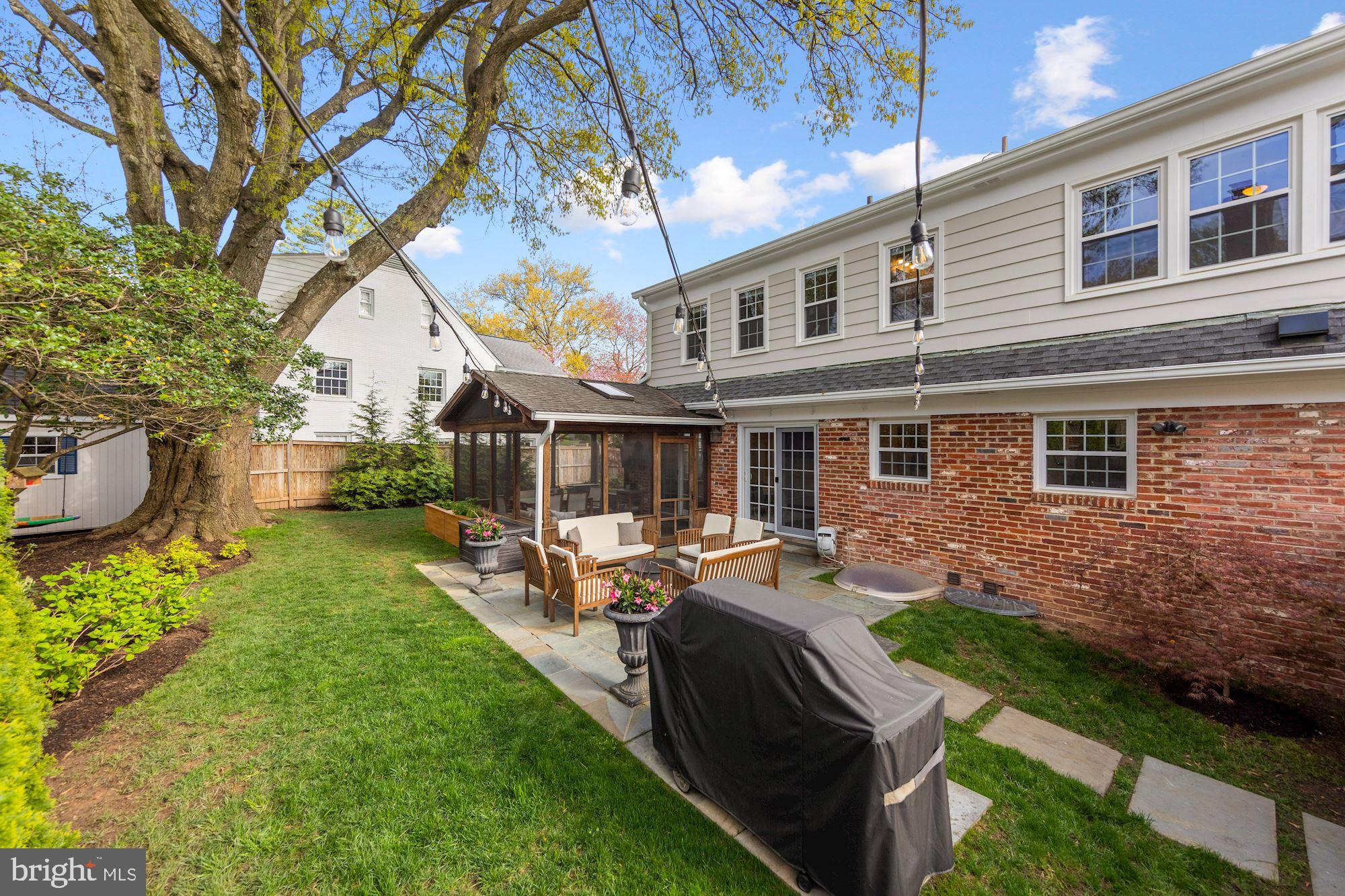 5500 Pollard Road Bethesda, MD 20816 - Photo 22 of 70 a front view of a house with a yard table and chairs