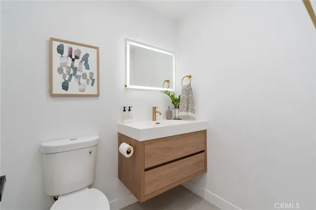 a bathroom with a toilet a sink and a mirror