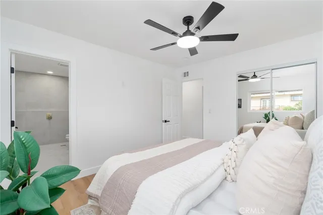 a bedroom with a large bed and a chandelier