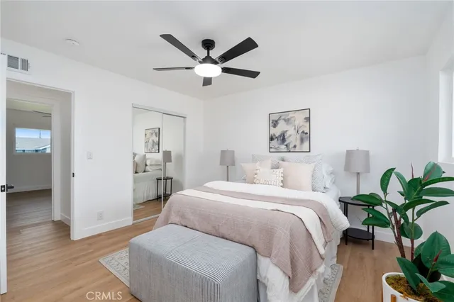 a bedroom with a bed and a potted plant
