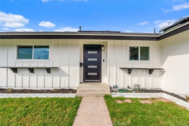 a front view of a house with a garden