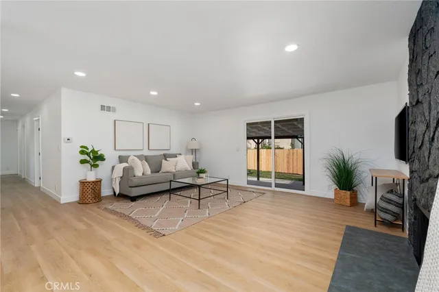 a living room with furniture and a potted plant