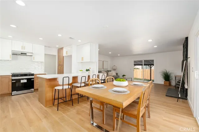 a large kitchen with a table and chairs