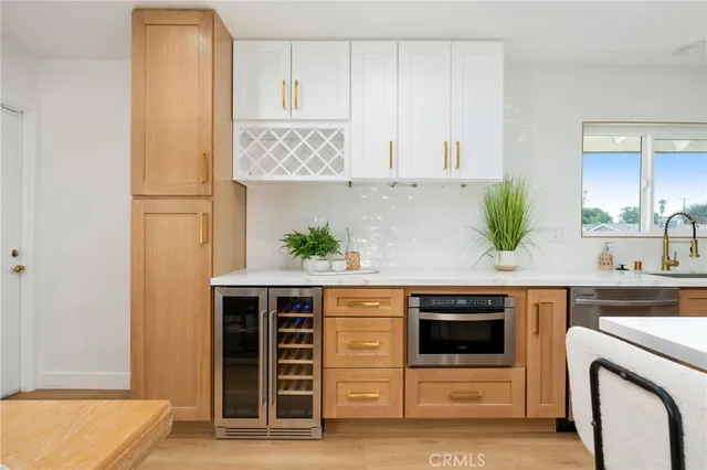 a kitchen with stainless steel appliances a stove a refrigerator and cabinets