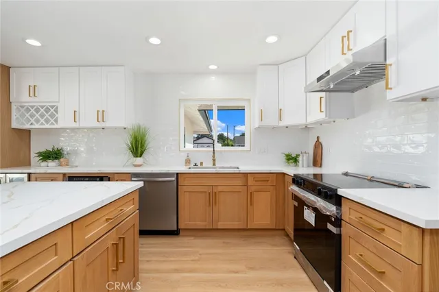 a kitchen with a sink white cabinets and white appliances