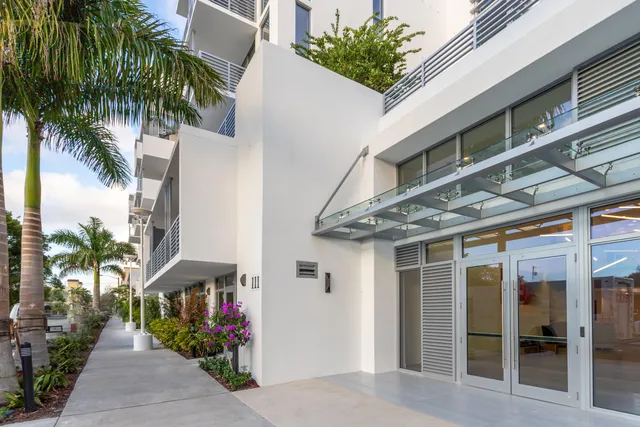 a front view of a building with tree s