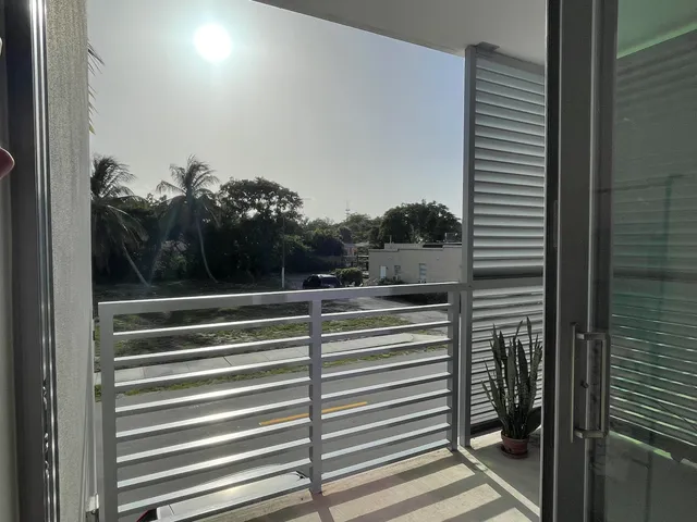 a view of balcony and floor to ceiling windows