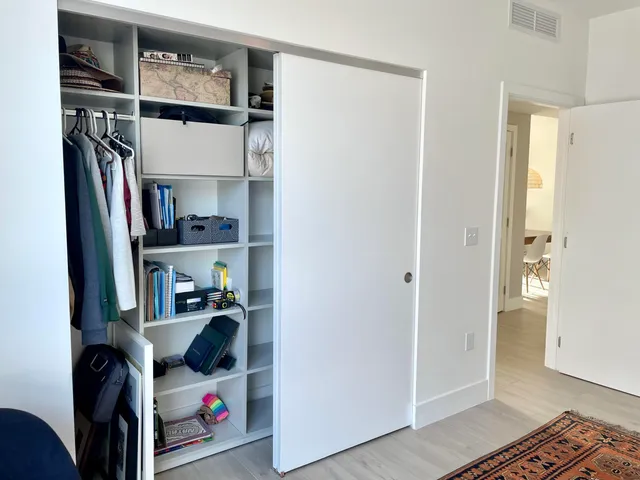 a view of walk in closet with clothes and shoes