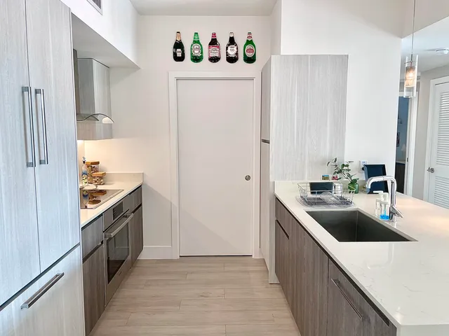 a kitchen with stainless steel appliances granite countertop a sink and a refrigerator
