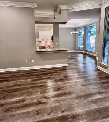 a view of a room with kitchen island and wooden floor