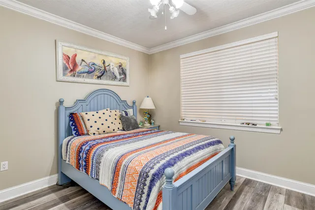 a bedroom with a bed and a painting on the wall