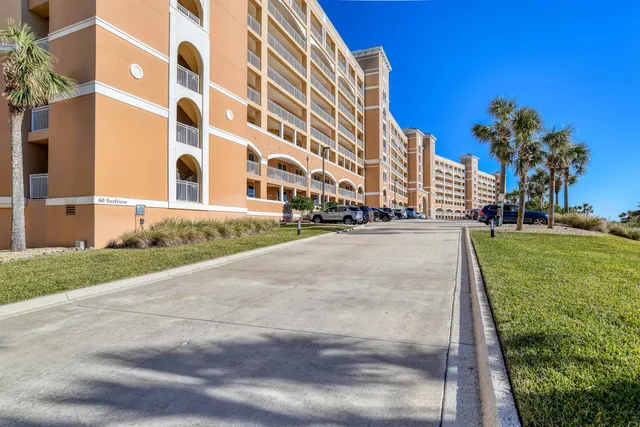 a view of a tall building with a yard