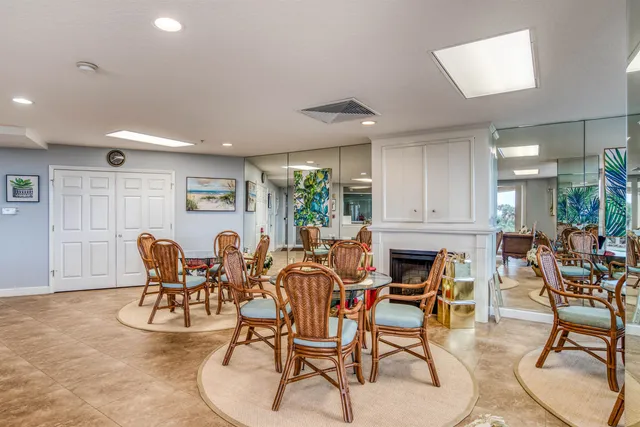 a view of a patio with table and chairs with wooden floor and fence