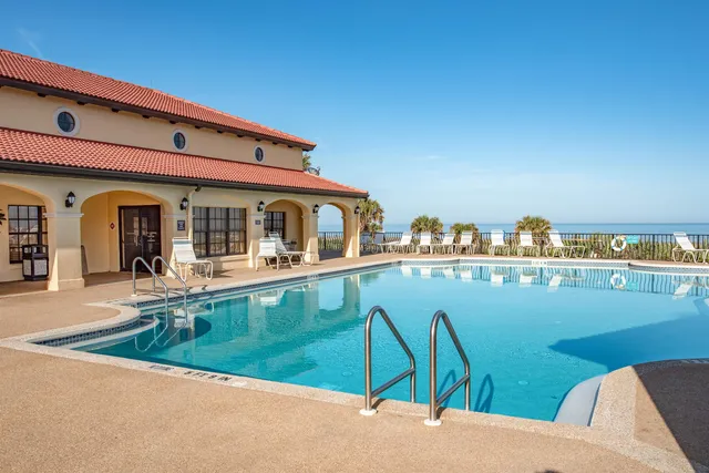 a view of a patio with table and chairs and potted plants