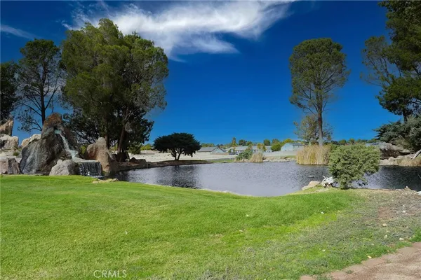 a swimming pool with outdoor seating and yard