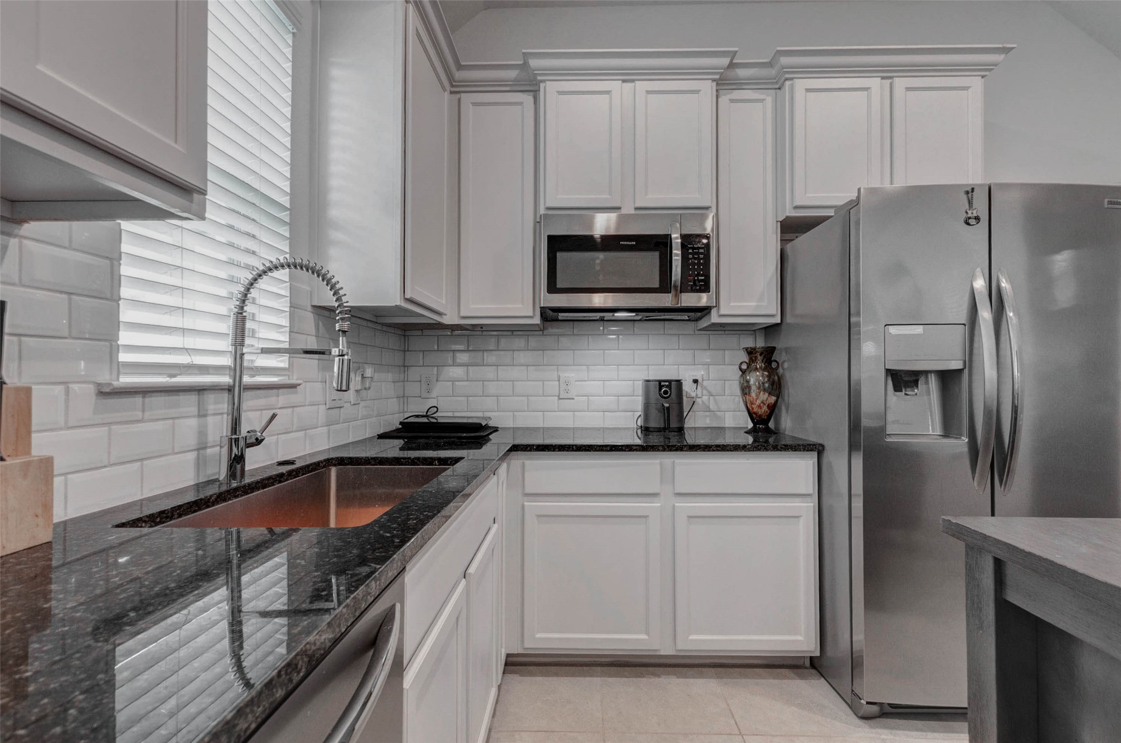 3711 Castle Rock Drive Rosenberg, TX 77469 - Photo 10 of 46 a kitchen with white cabinets and stainless steel appliances