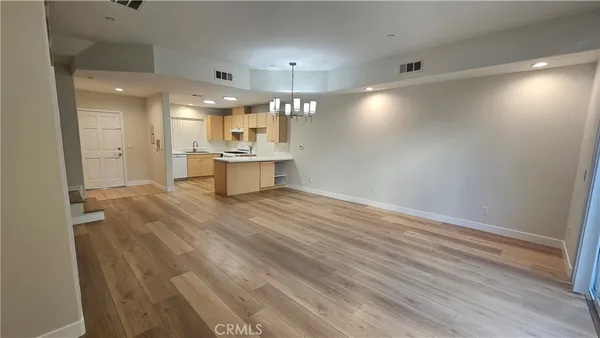 a large room with wooden floor and windows