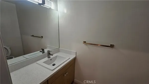 a bathroom with a sink toilet and mirror