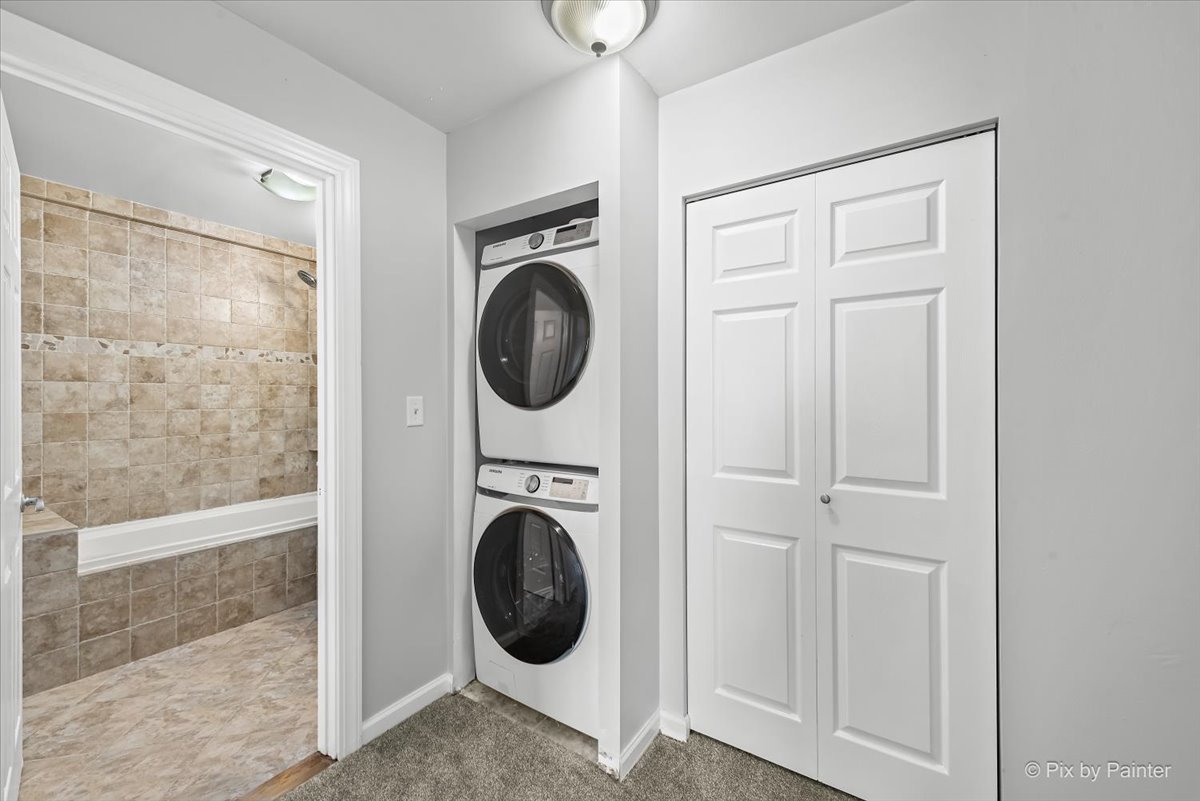 681 Elmhurst Road, Unit E Mount Prospect, IL 60056 - Photo 11 of 20 a view of a hallway with washer and dryer