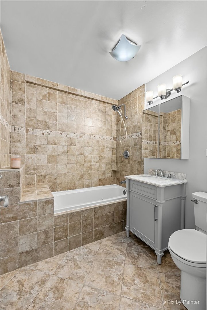 681 Elmhurst Road, Unit E Mount Prospect, IL 60056 - Photo 12 of 20 a bathroom with a sink a toilet and shower