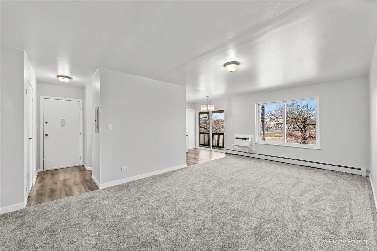 681 Elmhurst Road, Unit E Mount Prospect, IL 60056 - Photo 2 of 20 a view of a big room with closet and windows
