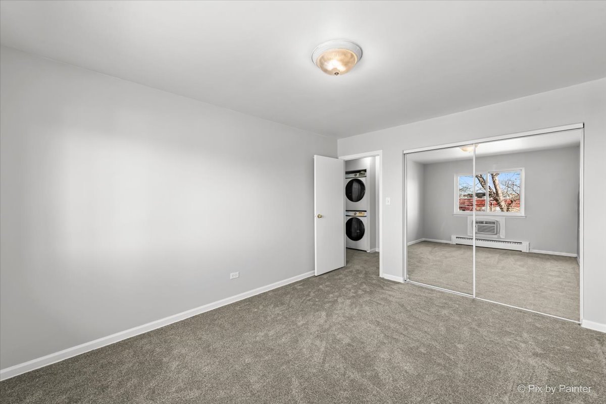681 Elmhurst Road, Unit E Mount Prospect, IL 60056 - Photo 10 of 20 an empty room with shelves and wall painting