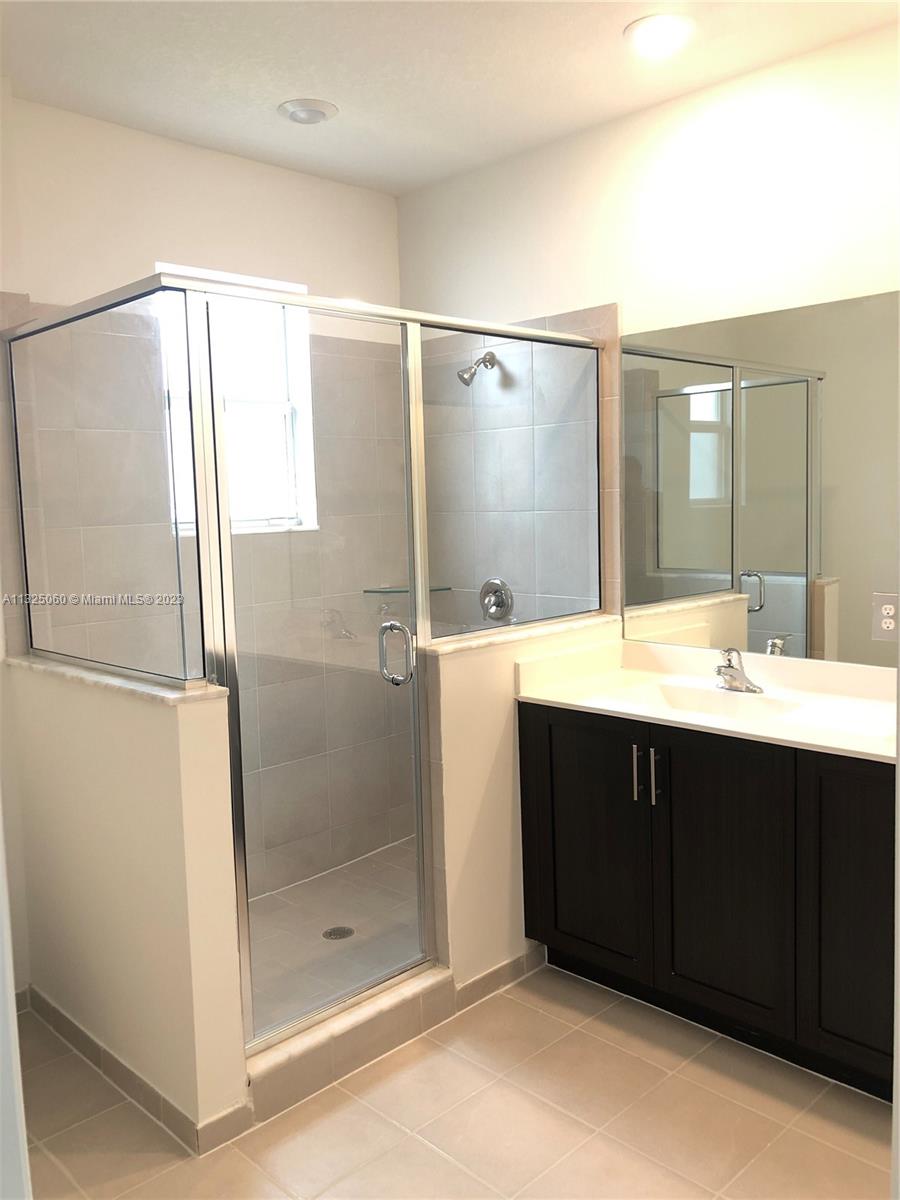 2610 Southeast 13th Street Homestead, FL 33035 - Photo 14 of 17 a bathroom with a shower sink and mirror