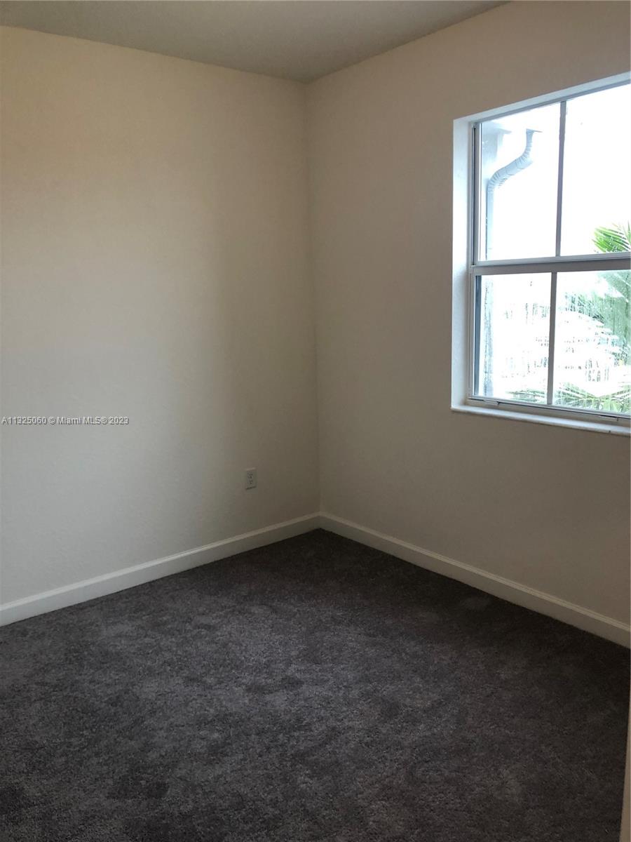 2610 Southeast 13th Street Homestead, FL 33035 - Photo 9 of 17 an empty room with a window